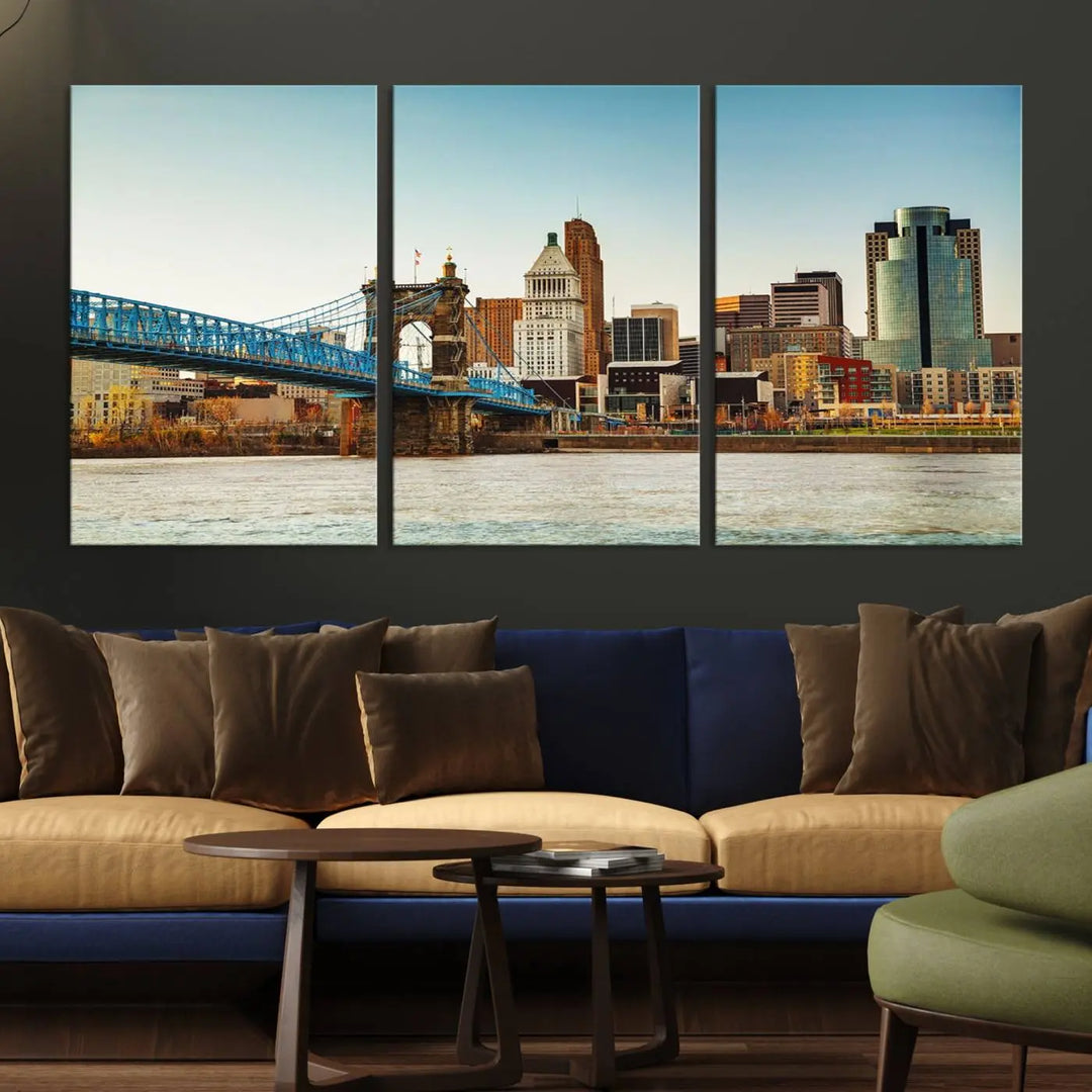 The Cincinnati City Morning Skyline Cityscape View Wall Art Canvas Print features three-panel museum-quality canvases depicting a city skyline with a bridge over a river. This gallery-wrapped artwork ensures an elegant finish and enduring beauty.