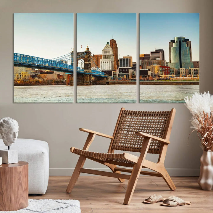 The Cincinnati City Morning Skyline Cityscape View Wall Art Canvas Print features three-panel museum-quality canvases depicting a city skyline with a bridge over a river. This gallery-wrapped artwork ensures an elegant finish and enduring beauty.