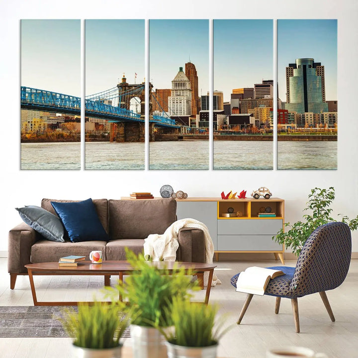 The Cincinnati City Morning Skyline Cityscape View Wall Art Canvas Print features three-panel museum-quality canvases depicting a city skyline with a bridge over a river. This gallery-wrapped artwork ensures an elegant finish and enduring beauty.