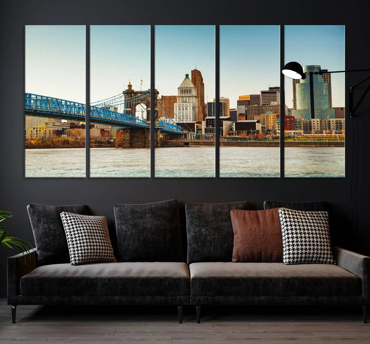 The Cincinnati City Morning Skyline Cityscape View Wall Art Canvas Print features three-panel museum-quality canvases depicting a city skyline with a bridge over a river. This gallery-wrapped artwork ensures an elegant finish and enduring beauty.