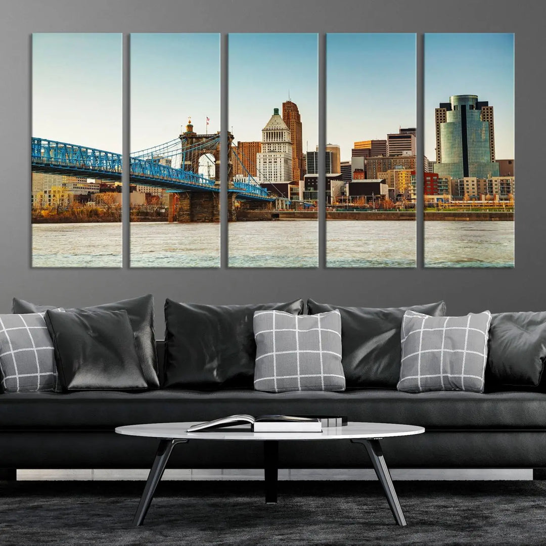 The Cincinnati City Morning Skyline Cityscape View Wall Art Canvas Print features three-panel museum-quality canvases depicting a city skyline with a bridge over a river. This gallery-wrapped artwork ensures an elegant finish and enduring beauty.