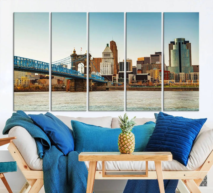 The Cincinnati City Morning Skyline Cityscape View Wall Art Canvas Print features three-panel museum-quality canvases depicting a city skyline with a bridge over a river. This gallery-wrapped artwork ensures an elegant finish and enduring beauty.