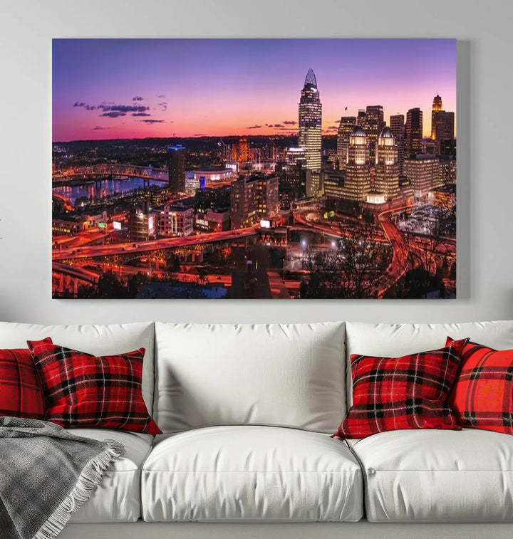 The Cincinnati City Sunset Purple Skyline Cityscape View Wall Art Canvas Print showcases a beautiful cityscape photo at sunset on a gallery-wrapped, museum-quality canvas. It is enhanced with a UV-protective coating to ensure lasting vibrancy and longevity.