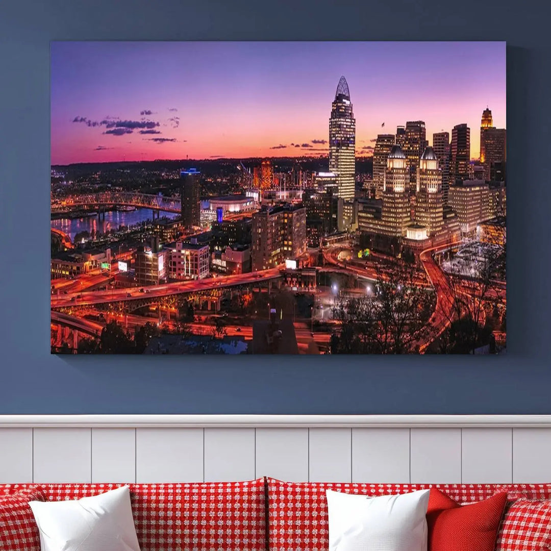 The Cincinnati City Sunset Purple Skyline Cityscape View Wall Art Canvas Print showcases a beautiful cityscape photo at sunset on a gallery-wrapped, museum-quality canvas. It is enhanced with a UV-protective coating to ensure lasting vibrancy and longevity.