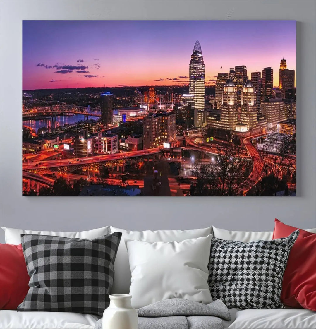 The Cincinnati City Sunset Purple Skyline Cityscape View Wall Art Canvas Print showcases a beautiful cityscape photo at sunset on a gallery-wrapped, museum-quality canvas. It is enhanced with a UV-protective coating to ensure lasting vibrancy and longevity.