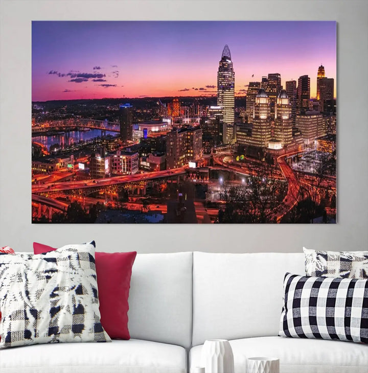 The Cincinnati City Sunset Purple Skyline Cityscape View Wall Art Canvas Print showcases a beautiful cityscape photo at sunset on a gallery-wrapped, museum-quality canvas. It is enhanced with a UV-protective coating to ensure lasting vibrancy and longevity.