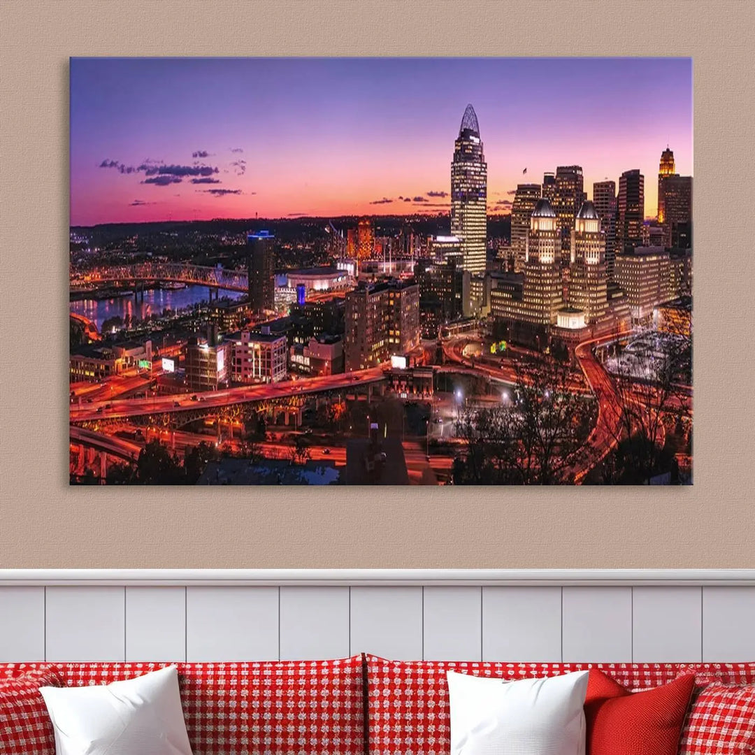 The Cincinnati City Sunset Purple Skyline Cityscape View Wall Art Canvas Print showcases a beautiful cityscape photo at sunset on a gallery-wrapped, museum-quality canvas. It is enhanced with a UV-protective coating to ensure lasting vibrancy and longevity.