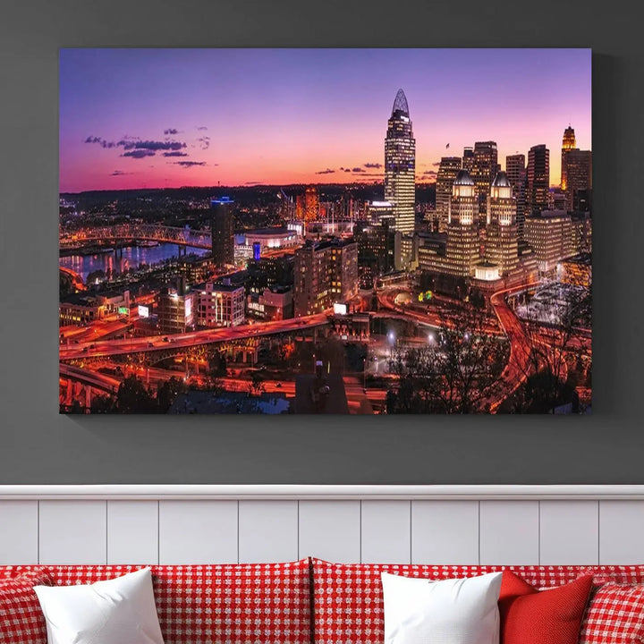 The Cincinnati City Sunset Purple Skyline Cityscape View Wall Art Canvas Print showcases a beautiful cityscape photo at sunset on a gallery-wrapped, museum-quality canvas. It is enhanced with a UV-protective coating to ensure lasting vibrancy and longevity.