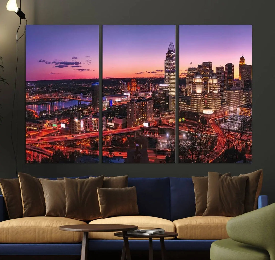 The Cincinnati City Sunset Purple Skyline Cityscape View Wall Art Canvas Print showcases a beautiful cityscape photo at sunset on a gallery-wrapped, museum-quality canvas. It is enhanced with a UV-protective coating to ensure lasting vibrancy and longevity.