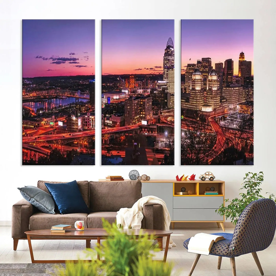 The Cincinnati City Sunset Purple Skyline Cityscape View Wall Art Canvas Print showcases a beautiful cityscape photo at sunset on a gallery-wrapped, museum-quality canvas. It is enhanced with a UV-protective coating to ensure lasting vibrancy and longevity.