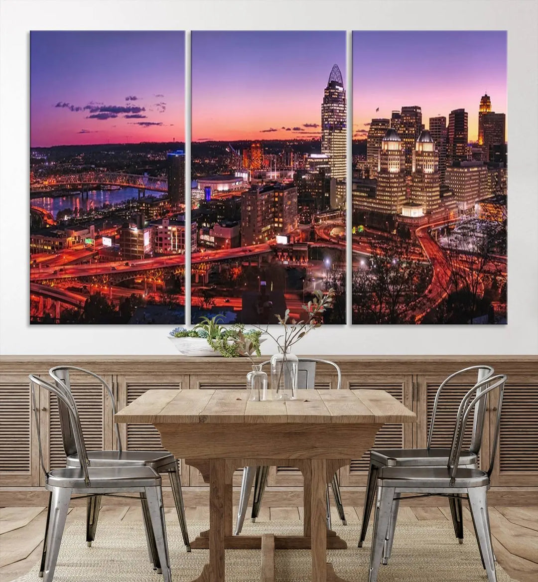 The Cincinnati City Sunset Purple Skyline Cityscape View Wall Art Canvas Print showcases a beautiful cityscape photo at sunset on a gallery-wrapped, museum-quality canvas. It is enhanced with a UV-protective coating to ensure lasting vibrancy and longevity.