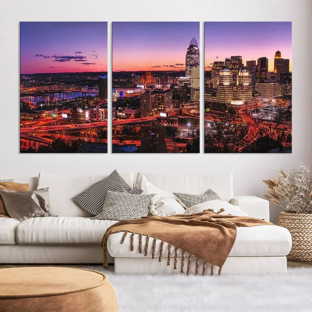 The Cincinnati City Sunset Purple Skyline Cityscape View Wall Art Canvas Print showcases a beautiful cityscape photo at sunset on a gallery-wrapped, museum-quality canvas. It is enhanced with a UV-protective coating to ensure lasting vibrancy and longevity.