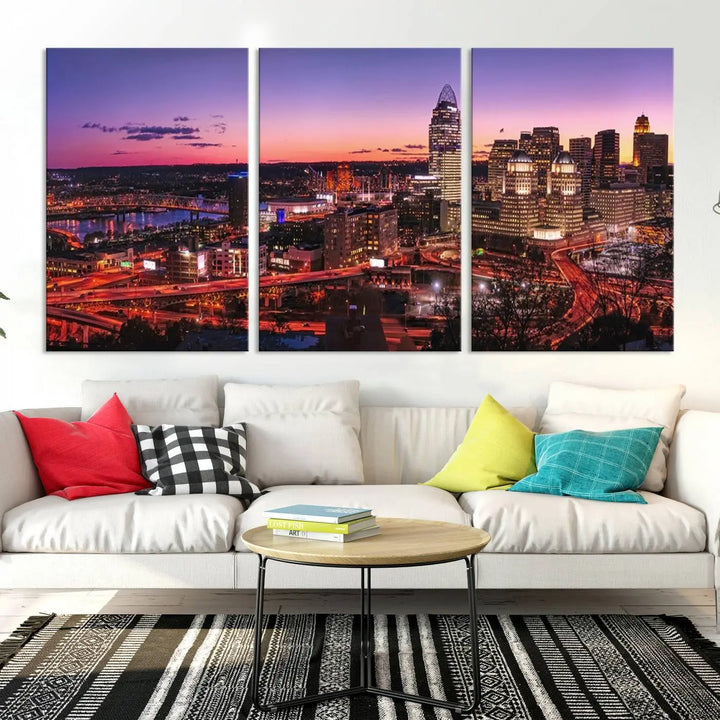 The Cincinnati City Sunset Purple Skyline Cityscape View Wall Art Canvas Print showcases a beautiful cityscape photo at sunset on a gallery-wrapped, museum-quality canvas. It is enhanced with a UV-protective coating to ensure lasting vibrancy and longevity.