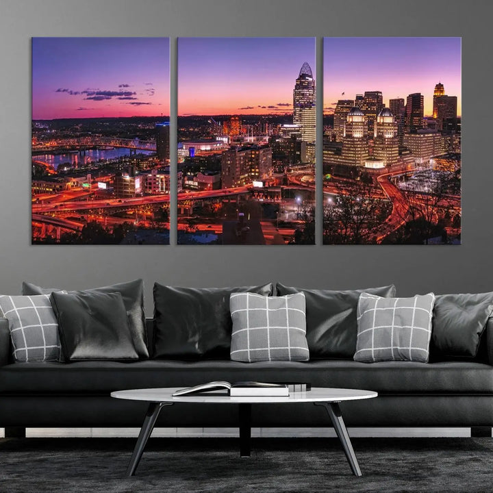 The Cincinnati City Sunset Purple Skyline Cityscape View Wall Art Canvas Print showcases a beautiful cityscape photo at sunset on a gallery-wrapped, museum-quality canvas. It is enhanced with a UV-protective coating to ensure lasting vibrancy and longevity.