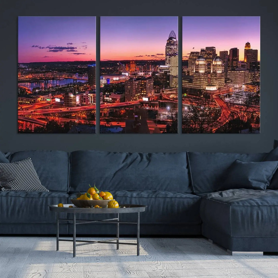 The Cincinnati City Sunset Purple Skyline Cityscape View Wall Art Canvas Print showcases a beautiful cityscape photo at sunset on a gallery-wrapped, museum-quality canvas. It is enhanced with a UV-protective coating to ensure lasting vibrancy and longevity.