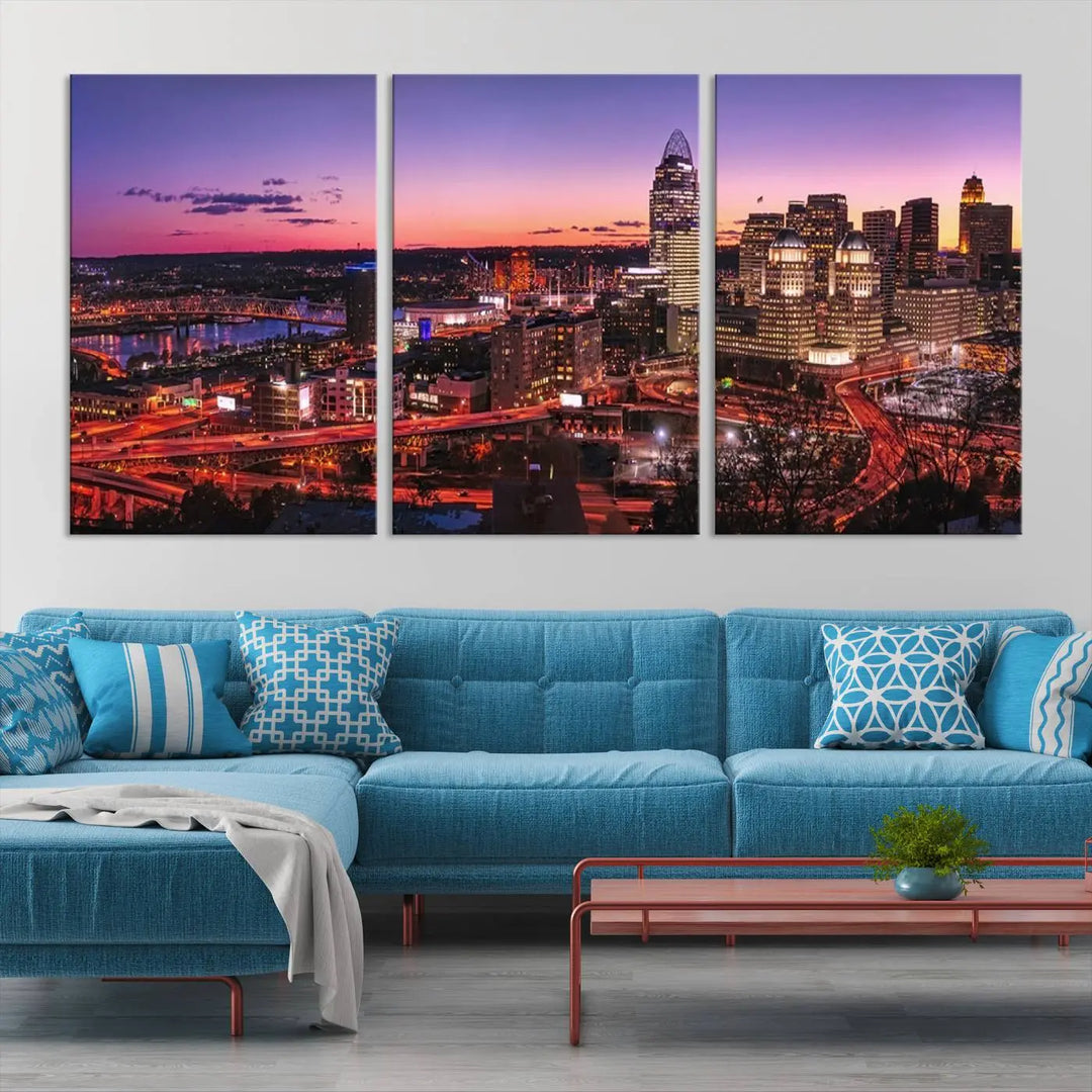 The Cincinnati City Sunset Purple Skyline Cityscape View Wall Art Canvas Print showcases a beautiful cityscape photo at sunset on a gallery-wrapped, museum-quality canvas. It is enhanced with a UV-protective coating to ensure lasting vibrancy and longevity.