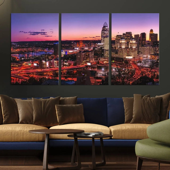 The Cincinnati City Sunset Purple Skyline Cityscape View Wall Art Canvas Print showcases a beautiful cityscape photo at sunset on a gallery-wrapped, museum-quality canvas. It is enhanced with a UV-protective coating to ensure lasting vibrancy and longevity.