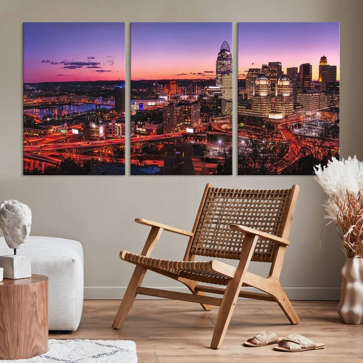 The Cincinnati City Sunset Purple Skyline Cityscape View Wall Art Canvas Print showcases a beautiful cityscape photo at sunset on a gallery-wrapped, museum-quality canvas. It is enhanced with a UV-protective coating to ensure lasting vibrancy and longevity.