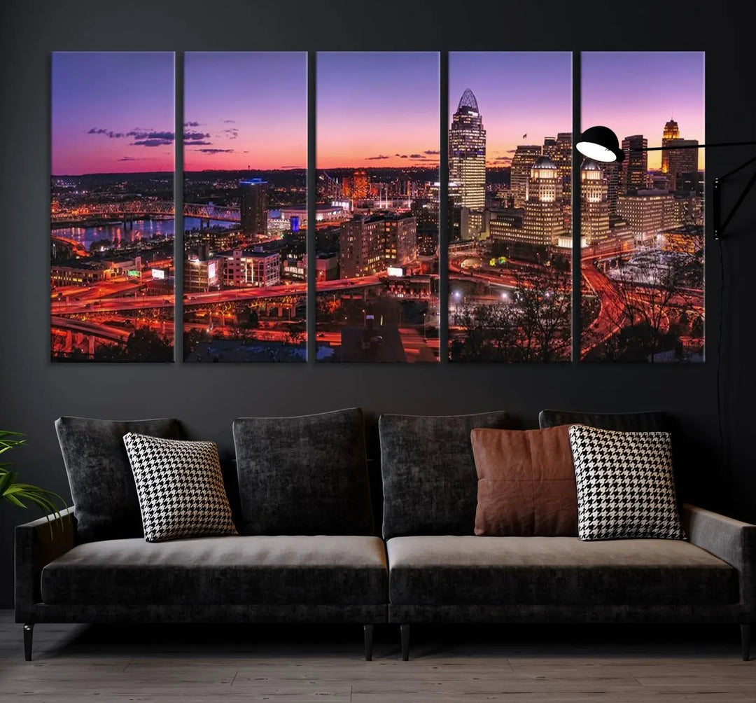 The Cincinnati City Sunset Purple Skyline Cityscape View Wall Art Canvas Print showcases a beautiful cityscape photo at sunset on a gallery-wrapped, museum-quality canvas. It is enhanced with a UV-protective coating to ensure lasting vibrancy and longevity.