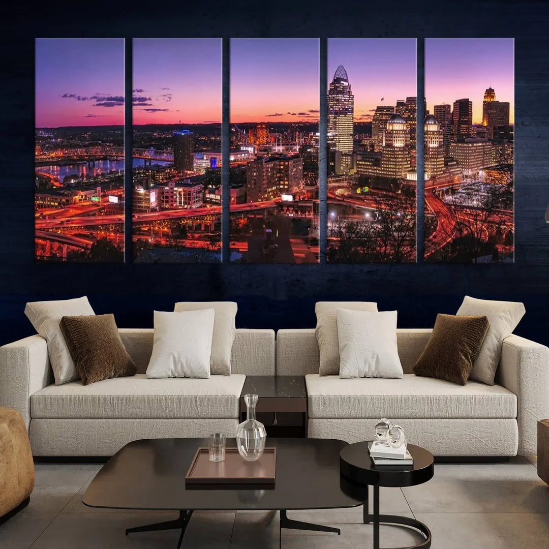 The Cincinnati City Sunset Purple Skyline Cityscape View Wall Art Canvas Print showcases a beautiful cityscape photo at sunset on a gallery-wrapped, museum-quality canvas. It is enhanced with a UV-protective coating to ensure lasting vibrancy and longevity.