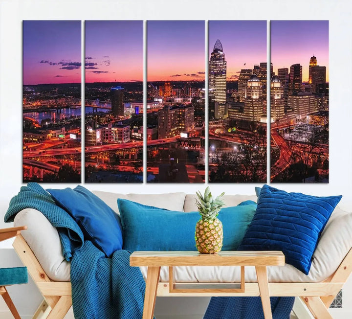 The Cincinnati City Sunset Purple Skyline Cityscape View Wall Art Canvas Print showcases a beautiful cityscape photo at sunset on a gallery-wrapped, museum-quality canvas. It is enhanced with a UV-protective coating to ensure lasting vibrancy and longevity.