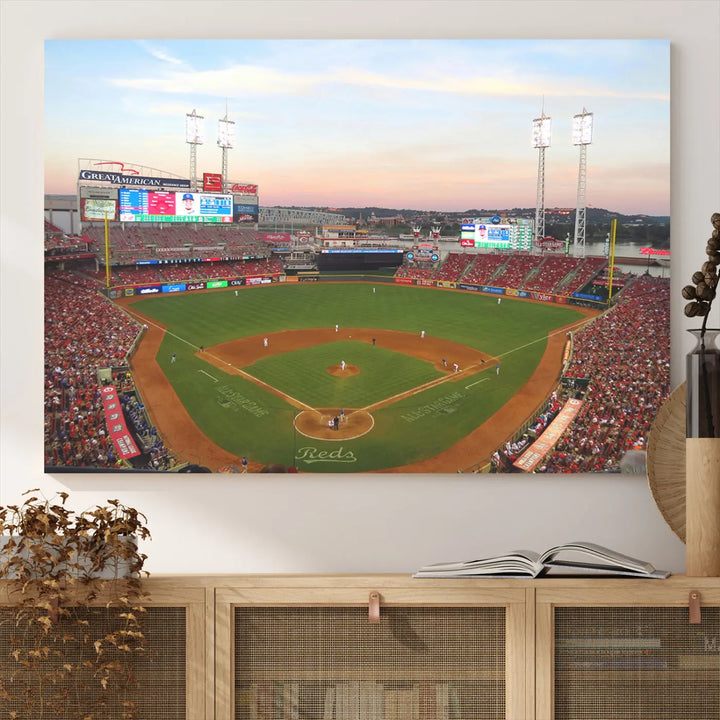 A canvas print of the Cincinnati Reds Baseball Team features a stunning image of the Great American Ball Park at sunset.