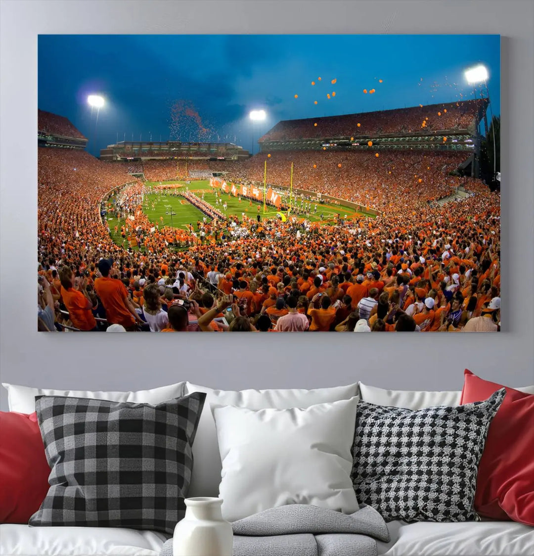 Imagine a stunning wall art canvas that captures the excitement and energy of a large football stadium packed with fans donned in orange. This Clemson University Tigers Football Team Print showcases Clemson Memorial Stadium under vibrant lights, transforming history into an enduring masterpiece.