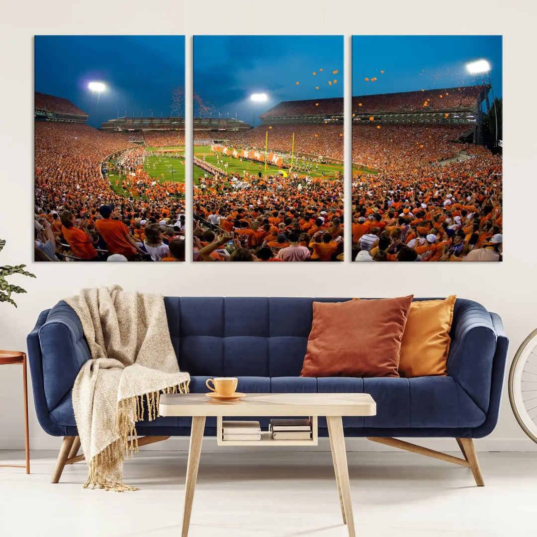 Imagine a stunning wall art canvas that captures the excitement and energy of a large football stadium packed with fans donned in orange. This Clemson University Tigers Football Team Print showcases Clemson Memorial Stadium under vibrant lights, transforming history into an enduring masterpiece.