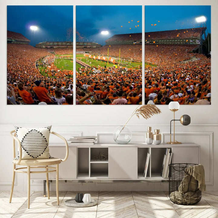 Imagine a stunning wall art canvas that captures the excitement and energy of a large football stadium packed with fans donned in orange. This Clemson University Tigers Football Team Print showcases Clemson Memorial Stadium under vibrant lights, transforming history into an enduring masterpiece.