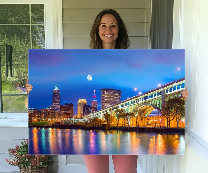 Dining room featuring a Cleveland Night Skyline Wall Art Cityscape Canvas Print with a lit-up bridge reflecting in the water.