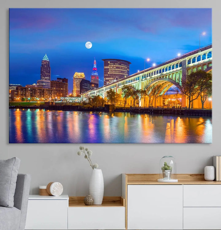 Dining room featuring a Cleveland Night Skyline Wall Art Cityscape Canvas Print with a lit-up bridge reflecting in the water.