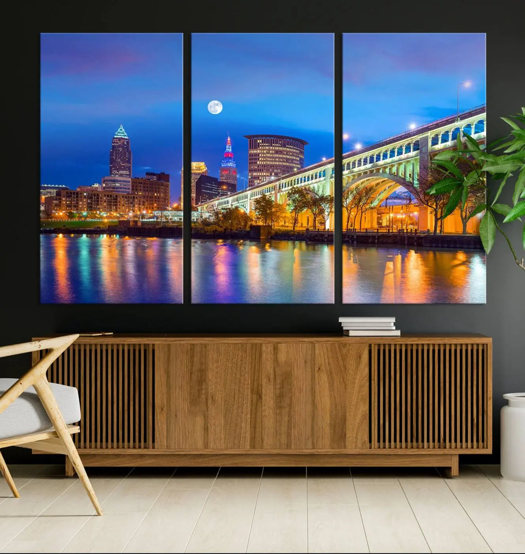 Dining room featuring a Cleveland Night Skyline Wall Art Cityscape Canvas Print with a lit-up bridge reflecting in the water.