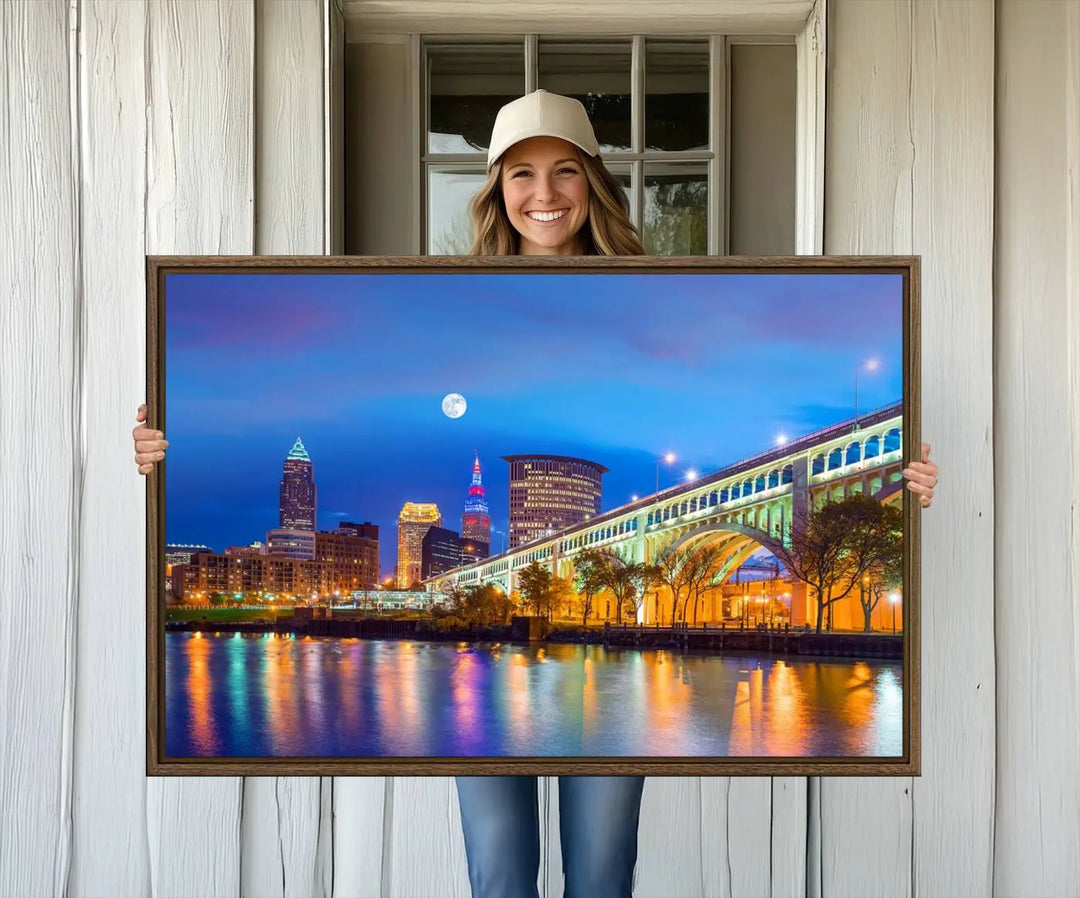 Dining room featuring a Cleveland Night Skyline Wall Art Cityscape Canvas Print with a lit-up bridge reflecting in the water.