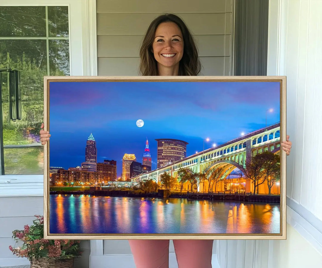 Dining room featuring a Cleveland Night Skyline Wall Art Cityscape Canvas Print with a lit-up bridge reflecting in the water.