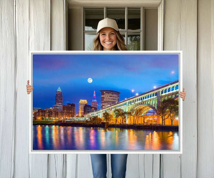 Dining room featuring a Cleveland Night Skyline Wall Art Cityscape Canvas Print with a lit-up bridge reflecting in the water.