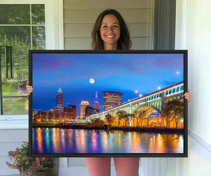 Dining room featuring a Cleveland Night Skyline Wall Art Cityscape Canvas Print with a lit-up bridge reflecting in the water.