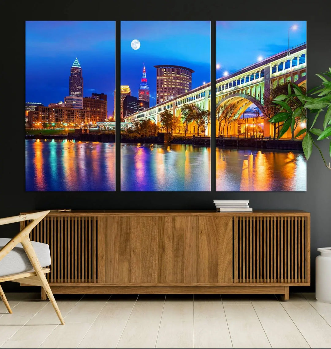 The living room features the "Cleveland Night Skyline Wall Art City Cityscape Canvas Print" prominently displayed, ready to hang.