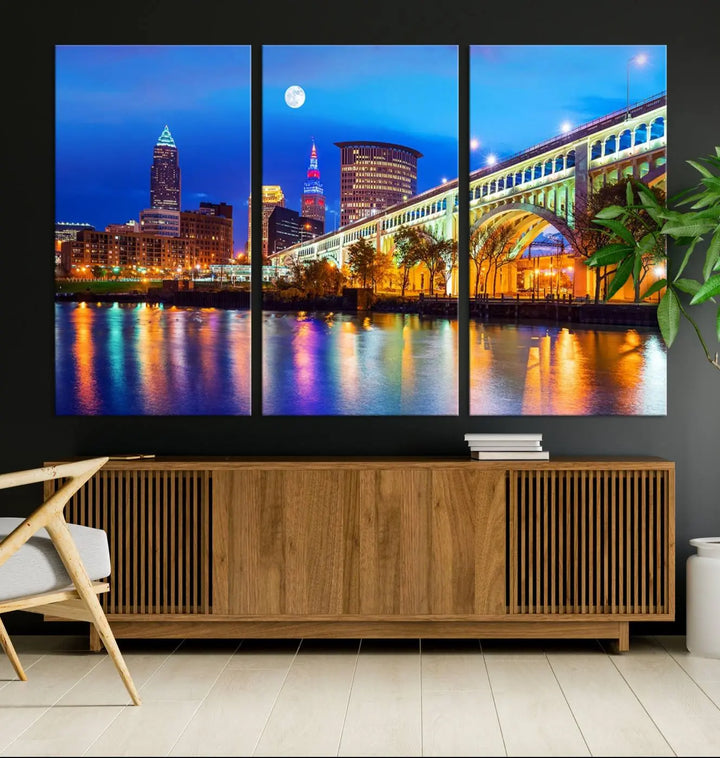 The living room features the "Cleveland Night Skyline Wall Art City Cityscape Canvas Print" prominently displayed, ready to hang.