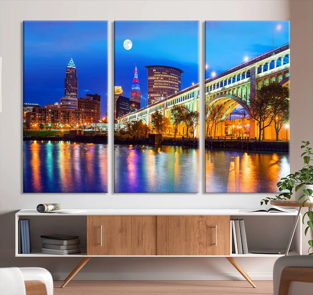 The living room features the "Cleveland Night Skyline Wall Art City Cityscape Canvas Print" prominently displayed, ready to hang.