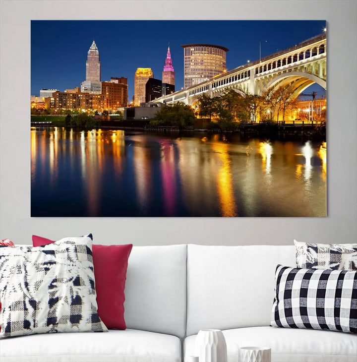 The "Cleveland Night Skyline Wall Art City Cityscape Canvas Print" is a striking feature in the room, showcasing a city skyline with a bridge reflecting in a river. Displayed on museum-quality canvas, it offers enduring beauty.