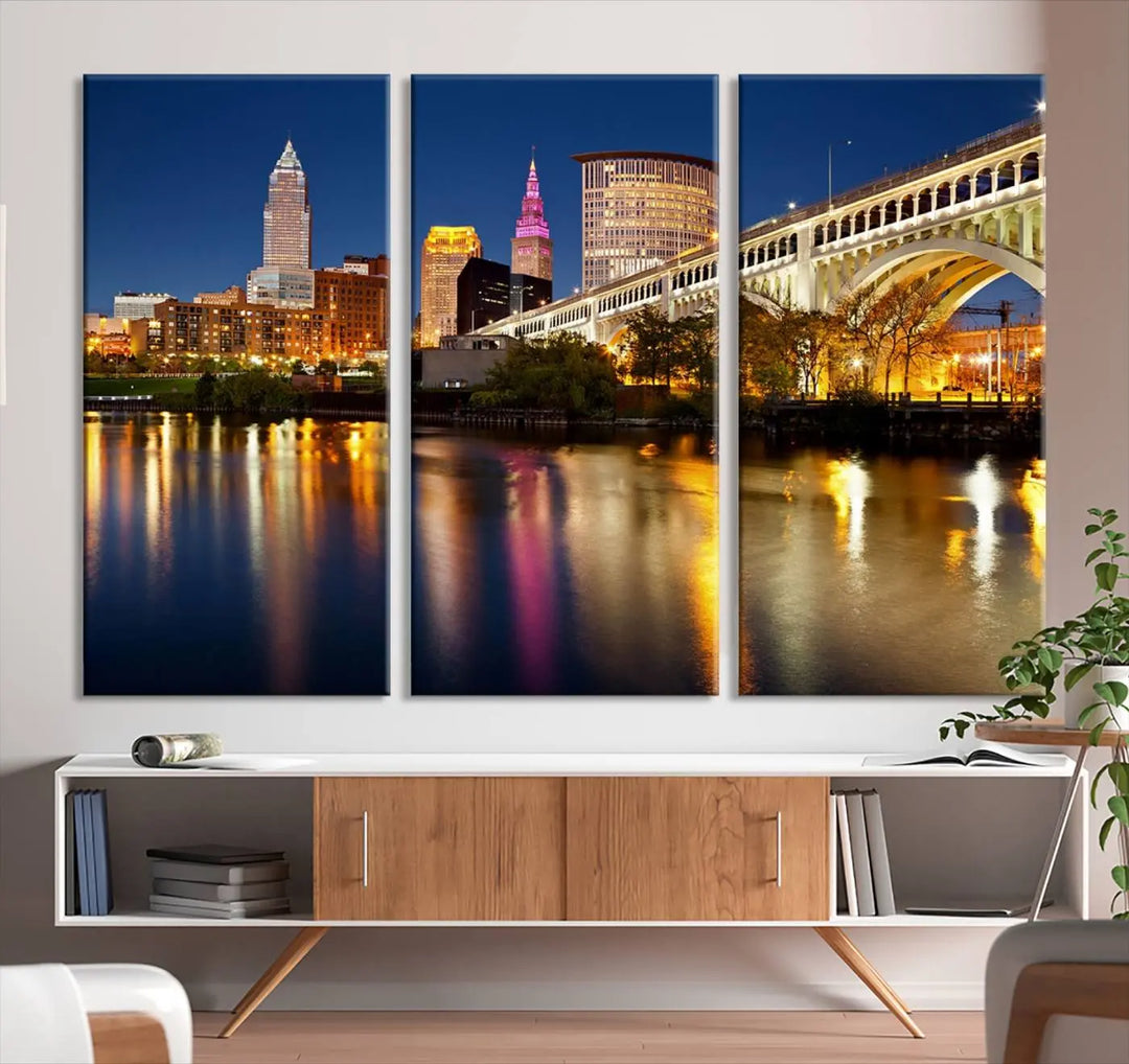 The "Cleveland Night Skyline Wall Art City Cityscape Canvas Print" is a striking feature in the room, showcasing a city skyline with a bridge reflecting in a river. Displayed on museum-quality canvas, it offers enduring beauty.