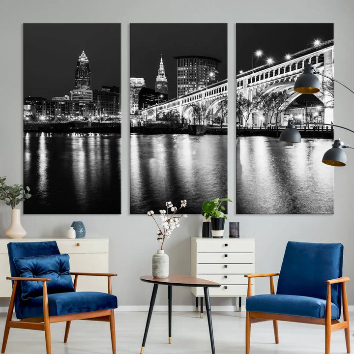 The "Cleveland Night Skyline Wall Art City Cityscape Canvas Print" is displayed in a black-and-white triptych on a gray wall. This gallery-wrapped artwork is printed on museum-quality canvas with a UV-protective coating, ensuring its striking details remain preserved for years.