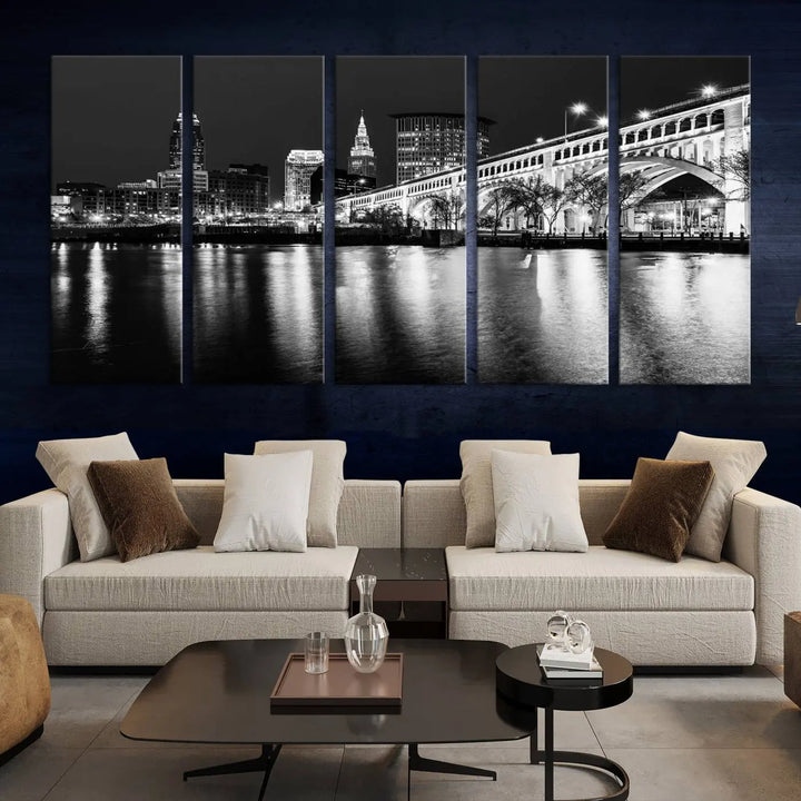 The "Cleveland Night Skyline Wall Art City Cityscape Canvas Print" is displayed in a black-and-white triptych on a gray wall. This gallery-wrapped artwork is printed on museum-quality canvas with a UV-protective coating, ensuring its striking details remain preserved for years.