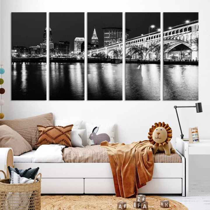 The "Cleveland Night Skyline Wall Art City Cityscape Canvas Print" is displayed in a black-and-white triptych on a gray wall. This gallery-wrapped artwork is printed on museum-quality canvas with a UV-protective coating, ensuring its striking details remain preserved for years.