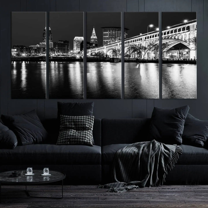 The "Cleveland Night Skyline Wall Art City Cityscape Canvas Print" is displayed in a black-and-white triptych on a gray wall. This gallery-wrapped artwork is printed on museum-quality canvas with a UV-protective coating, ensuring its striking details remain preserved for years.