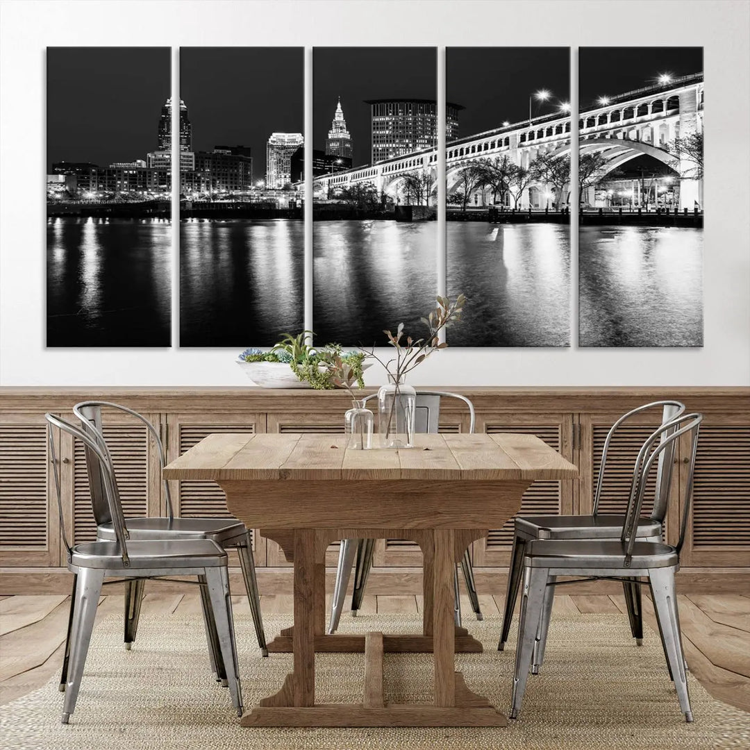 The "Cleveland Night Skyline Wall Art City Cityscape Canvas Print" is displayed in a black-and-white triptych on a gray wall. This gallery-wrapped artwork is printed on museum-quality canvas with a UV-protective coating, ensuring its striking details remain preserved for years.