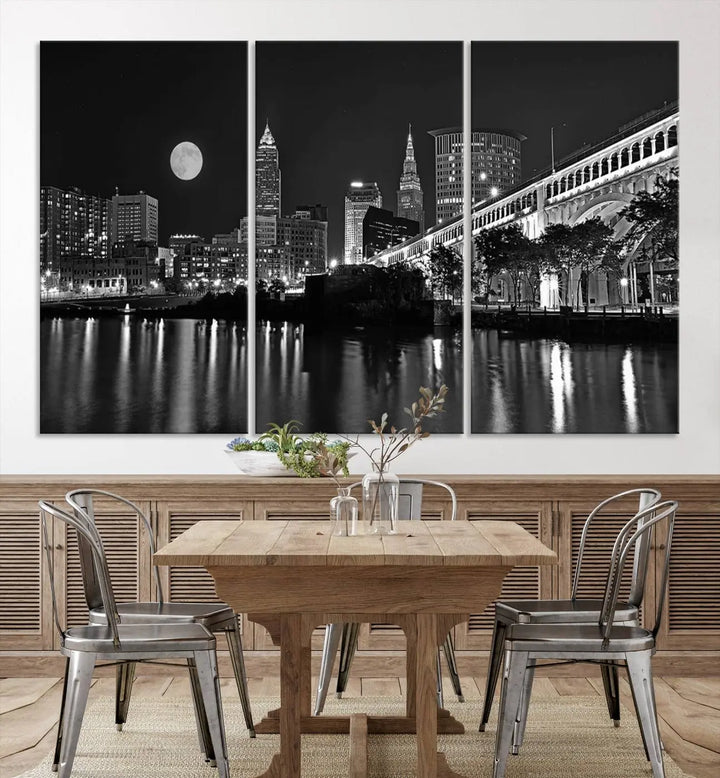 A modern living room features the "Cleveland Night Skyline Wall Art City Cityscape Canvas Print" on the wall, showcasing a moonlit skyline and river. It is professionally gallery wrapped on museum-quality canvas for enduring elegance.