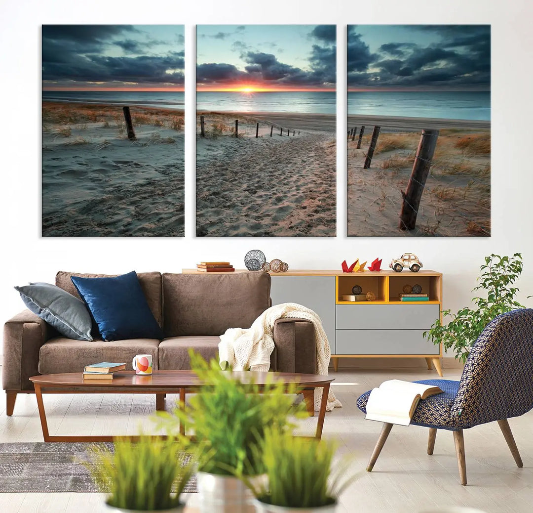 The modern living room features the Cloudy Weather Sunset Beach Wall Art Canvas Print. This museum-quality canvas adds a touch of sophistication with its hand-assembled framed art, ensuring lasting elegance. Enjoy free shipping on this exquisite piece.