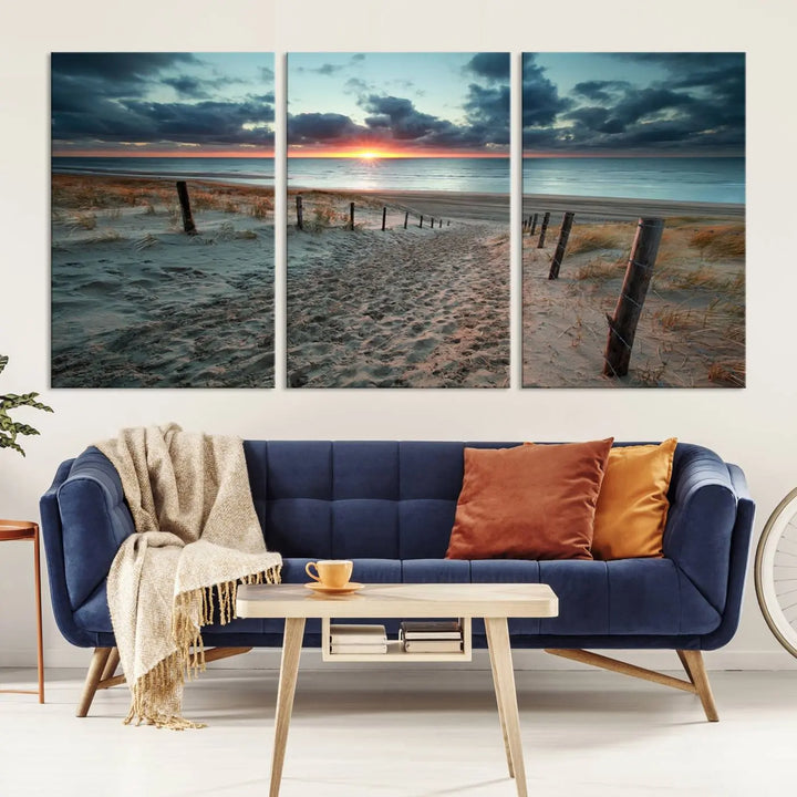 The modern living room features the Cloudy Weather Sunset Beach Wall Art Canvas Print. This museum-quality canvas adds a touch of sophistication with its hand-assembled framed art, ensuring lasting elegance. Enjoy free shipping on this exquisite piece.