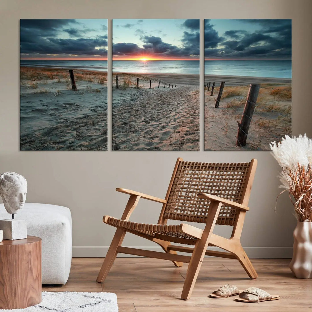 The modern living room features the Cloudy Weather Sunset Beach Wall Art Canvas Print. This museum-quality canvas adds a touch of sophistication with its hand-assembled framed art, ensuring lasting elegance. Enjoy free shipping on this exquisite piece.